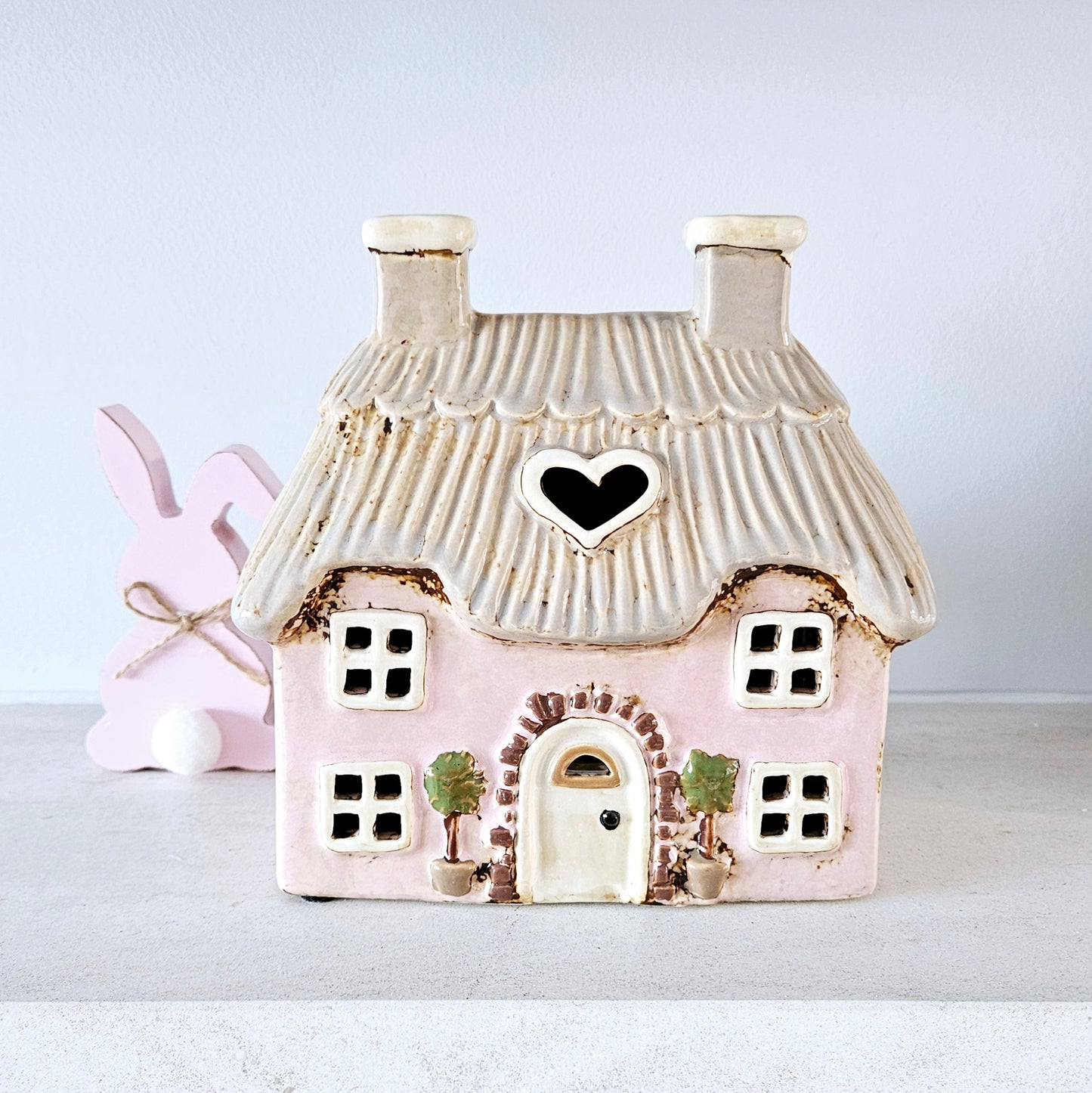 PINK STONEWARE COTTAGE TEALIGHT HOLDER WITH EMBOSSED TREES