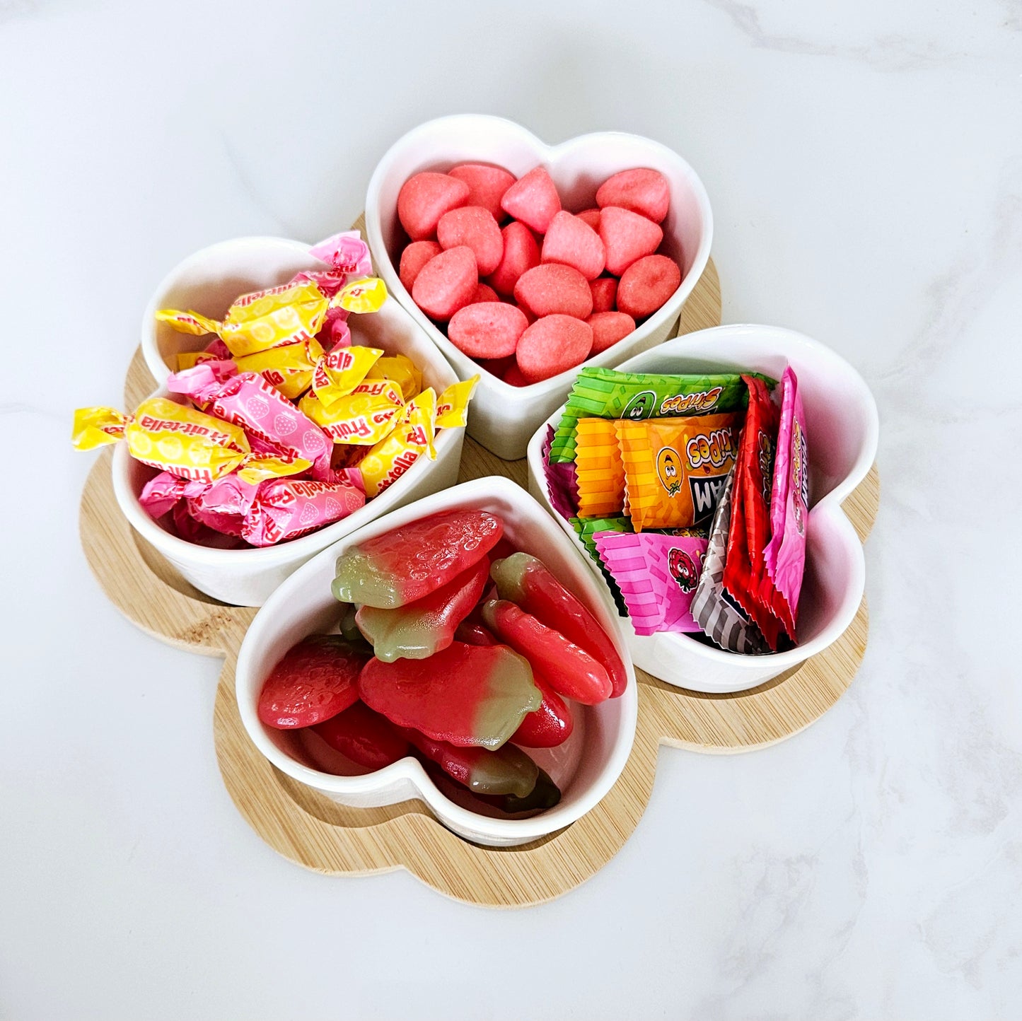 Heart shaped ceramic snacking station on a wooden base