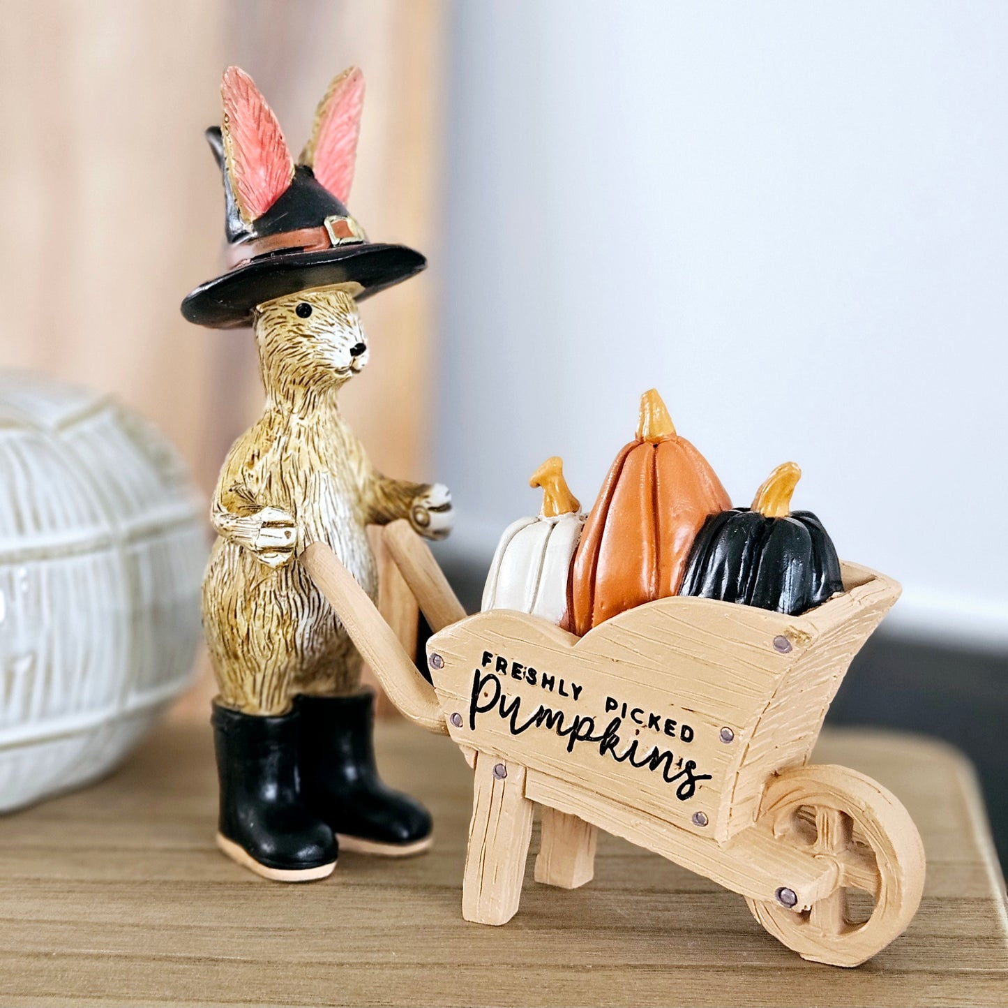 wizard rabbit ornament wearing a witches hat and black boots with a wheelbarrow saying freshly picked pumpkins and filled with pumpkins