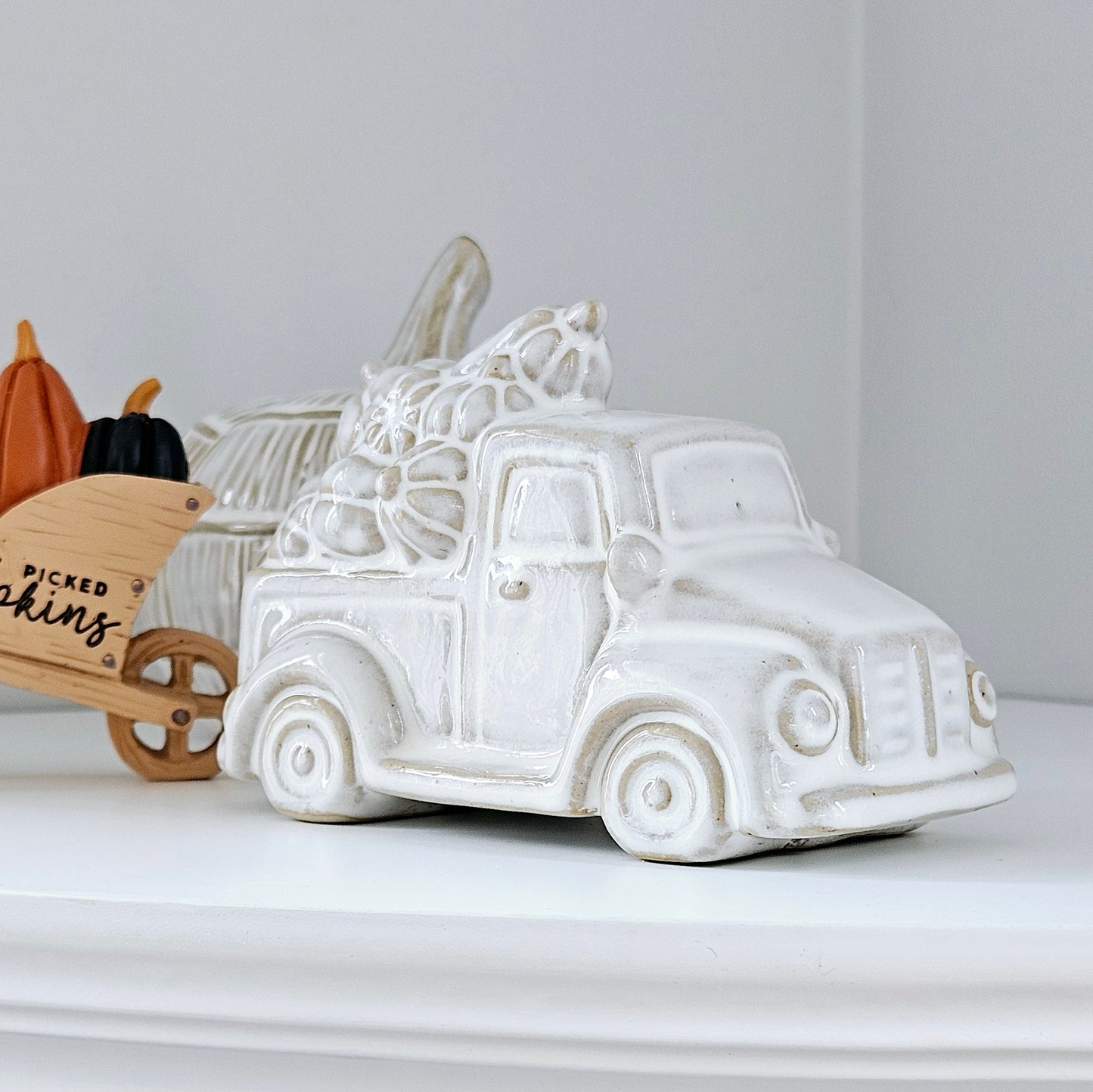 ceramic pumpkin truck with brown white and beige tones and pumpkins on the roof