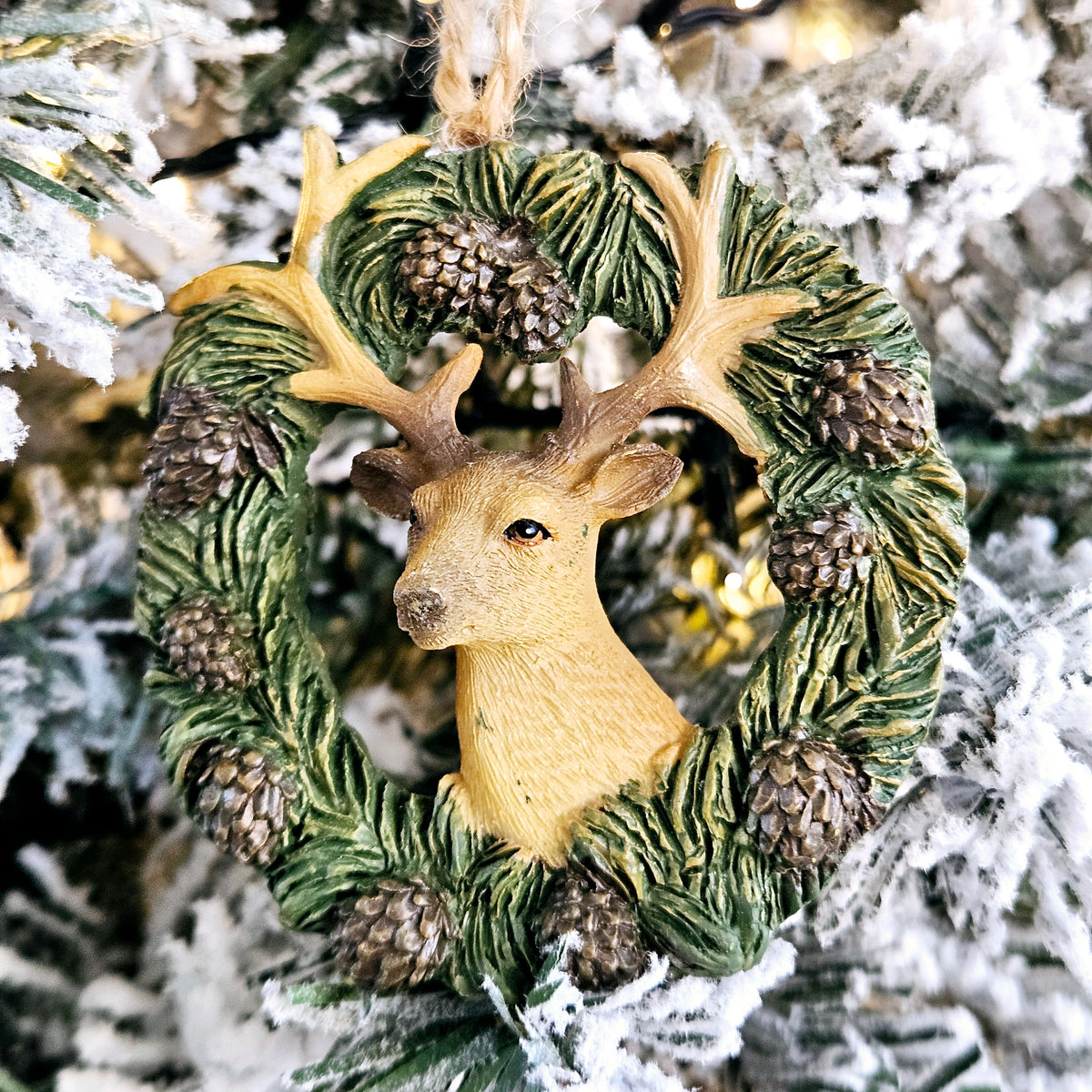 Reindeer and pinecone Christmas tree decoration with faux wood effect