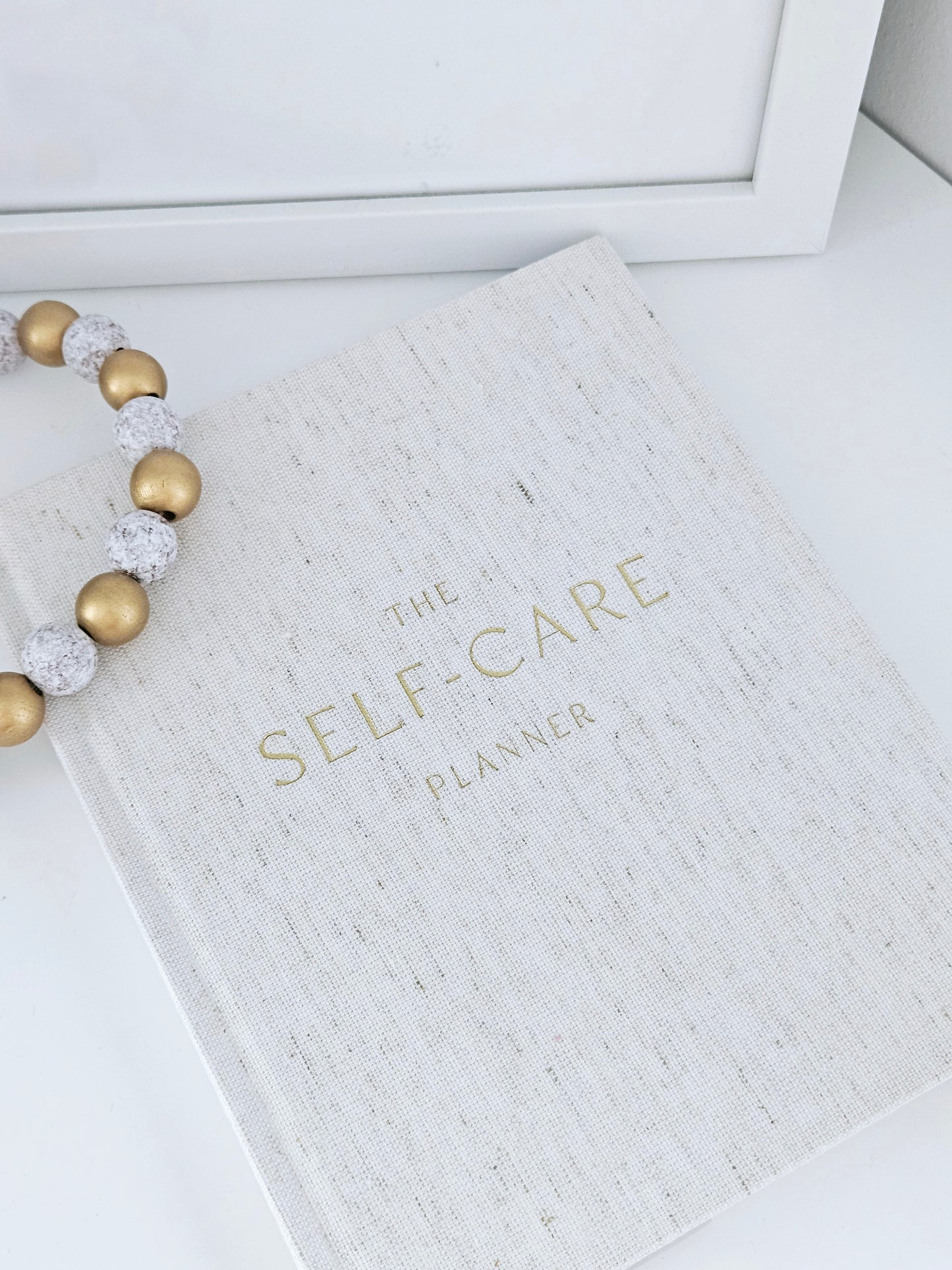 the self care planner journal with gold font cover by Sophia hardback