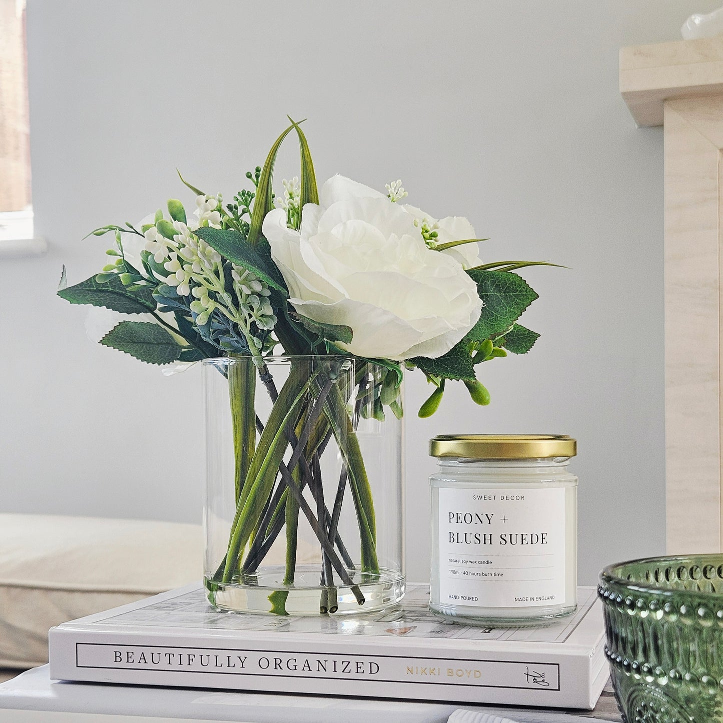 artificial roses in a glass pot by candlelight home