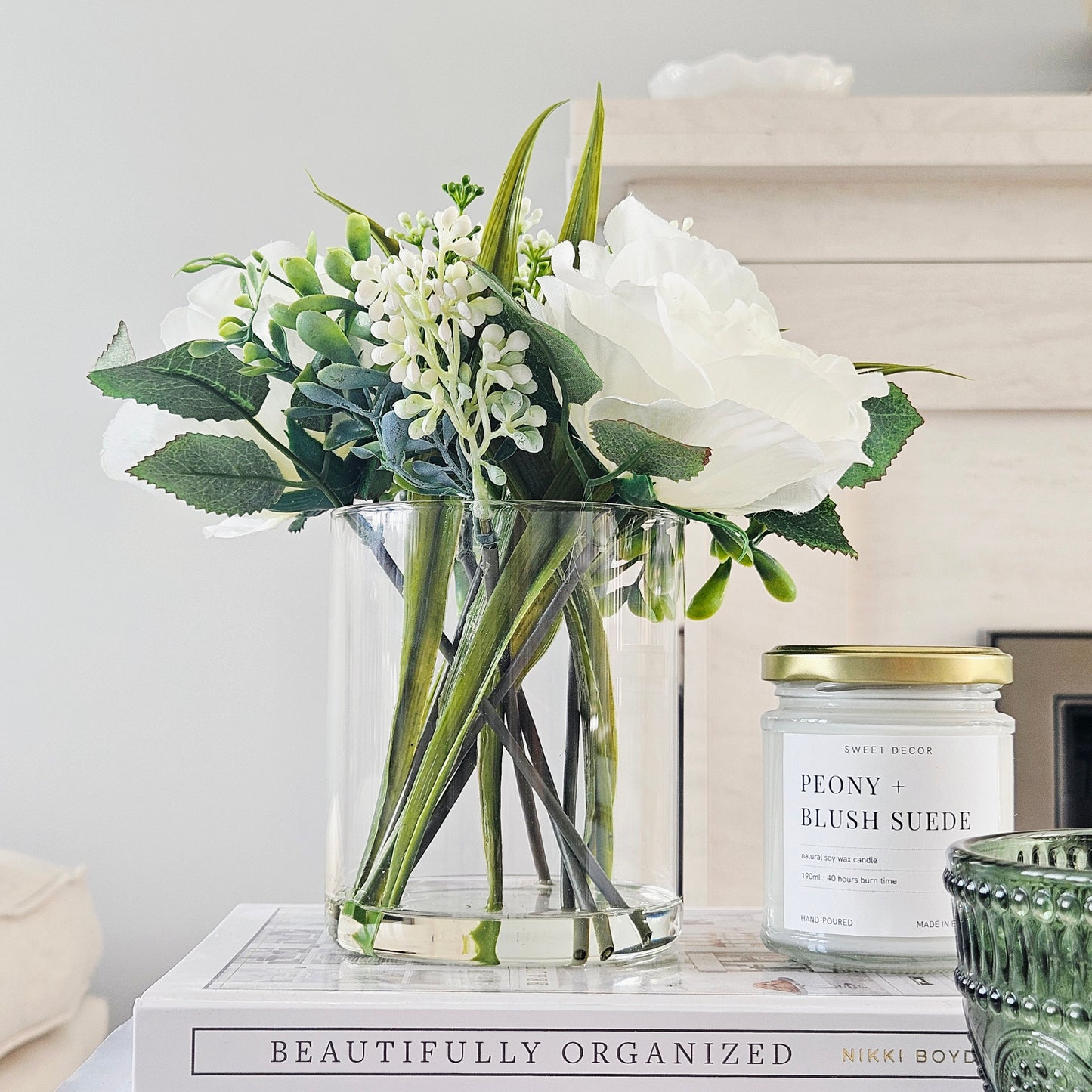 artificial roses in a glass pot by candlelight home