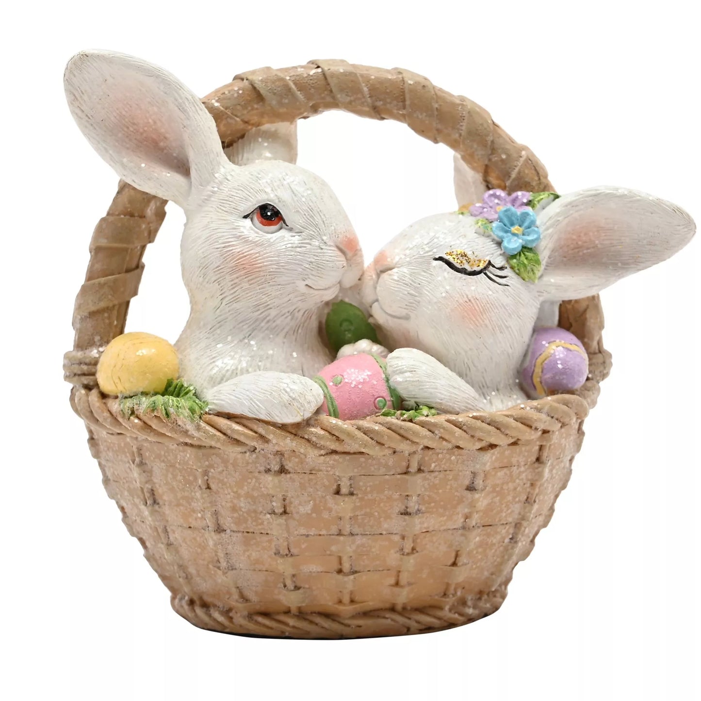 Decorative figurines of two rabbits in a basket with Easter eggs snuggled up
