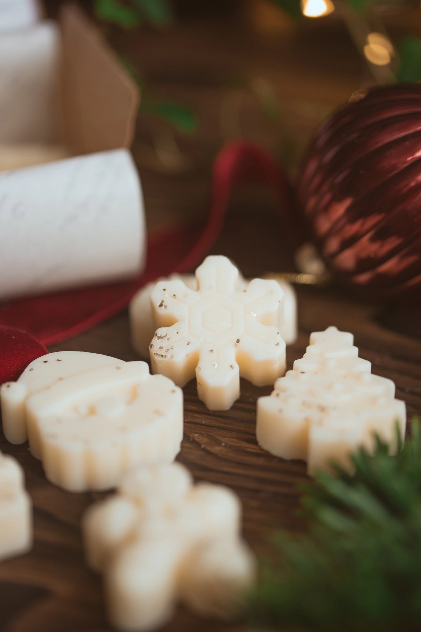 Decorative wax melts shaped like snowflakes, Christmas trees, and santa
