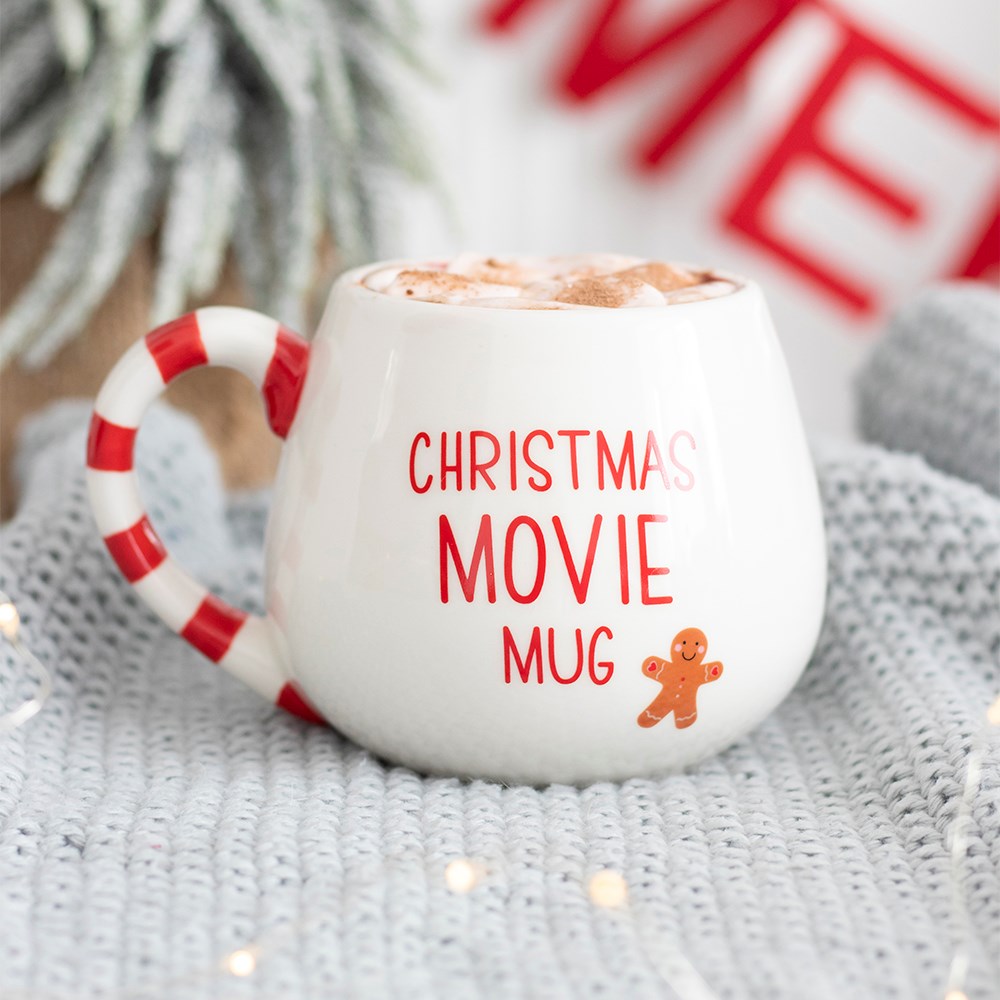 White mug with red Candy cane handle featuring 'Christmas Movie Mug' text and gingerbread picture