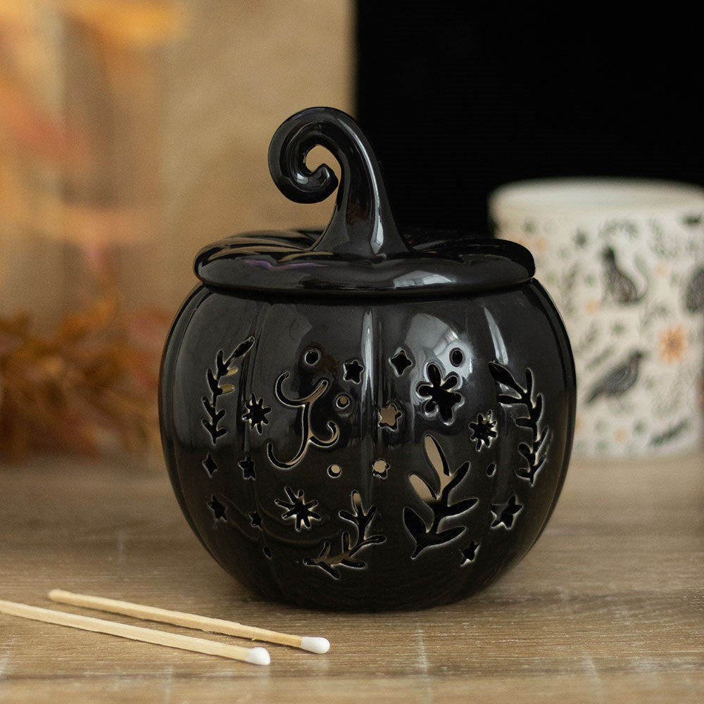 Black ceramic pumpkin-shaped wax warmer and oil burner in folk design