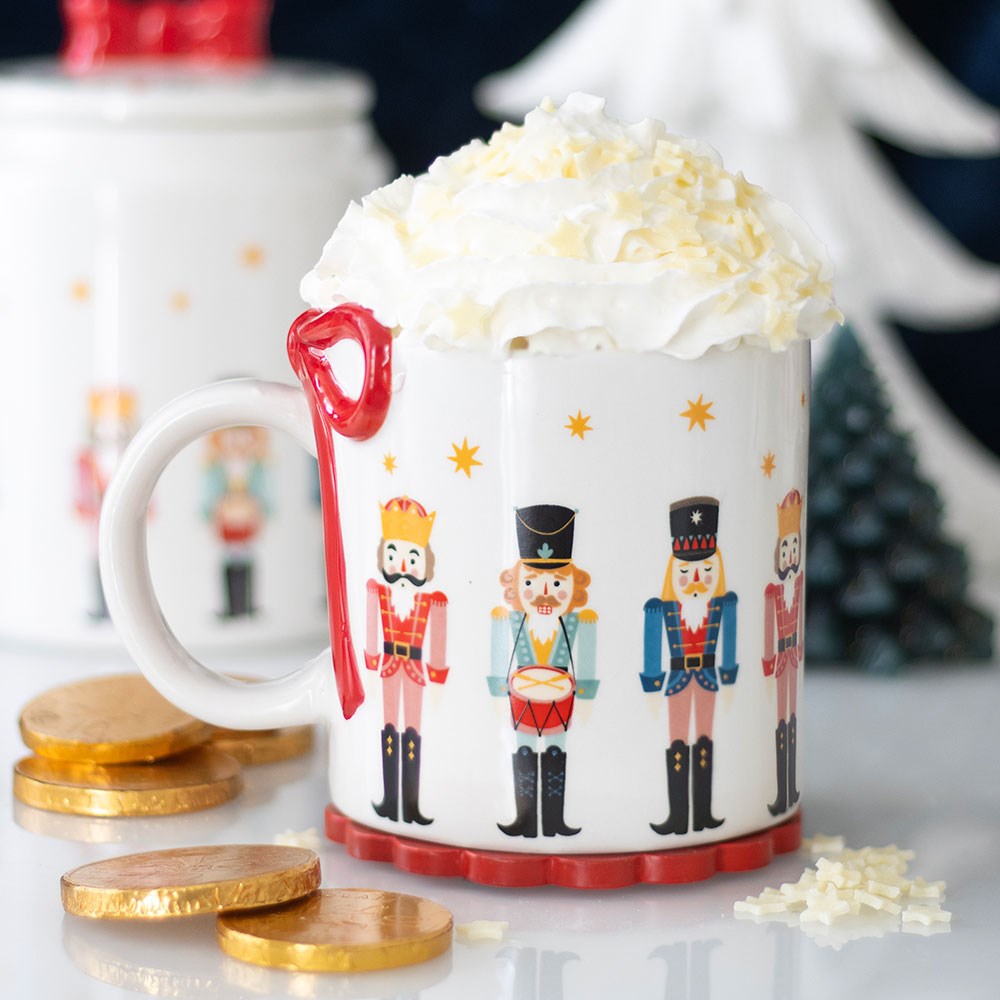 nutcracker designed mug with red bow over the handle