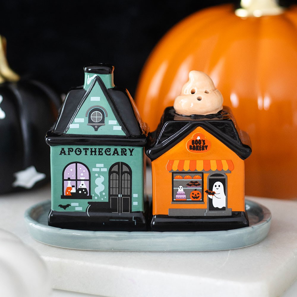 Halloween-themed salt and pepper shakers resembling a haunted house and a ghostly figure spooky street