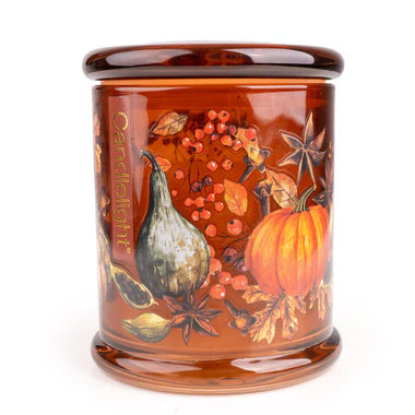 Large pumpkin glass scented candle with autumn flora and fauna design in decorative glass jar