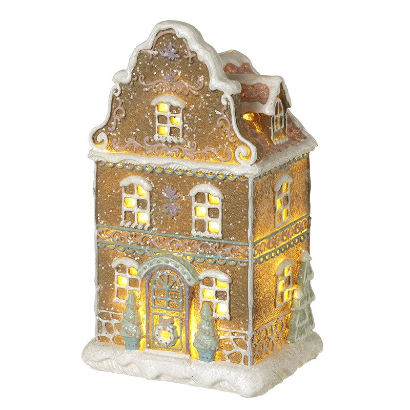 Decorative gingerbread house-shaped light with gold and white design and pastel colours
