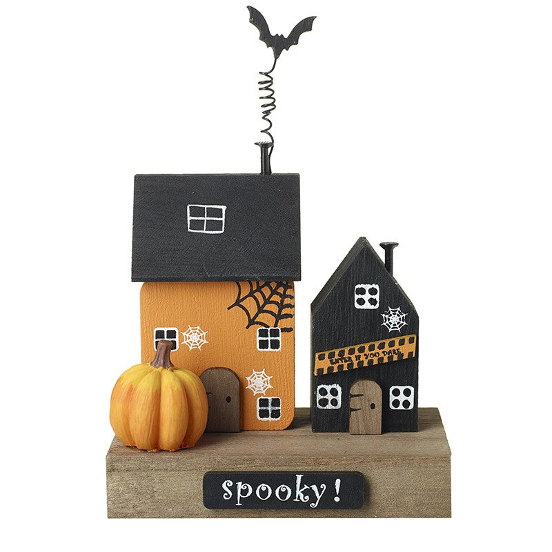 Halloween-themed decorative house set with pumpkins and a bat
