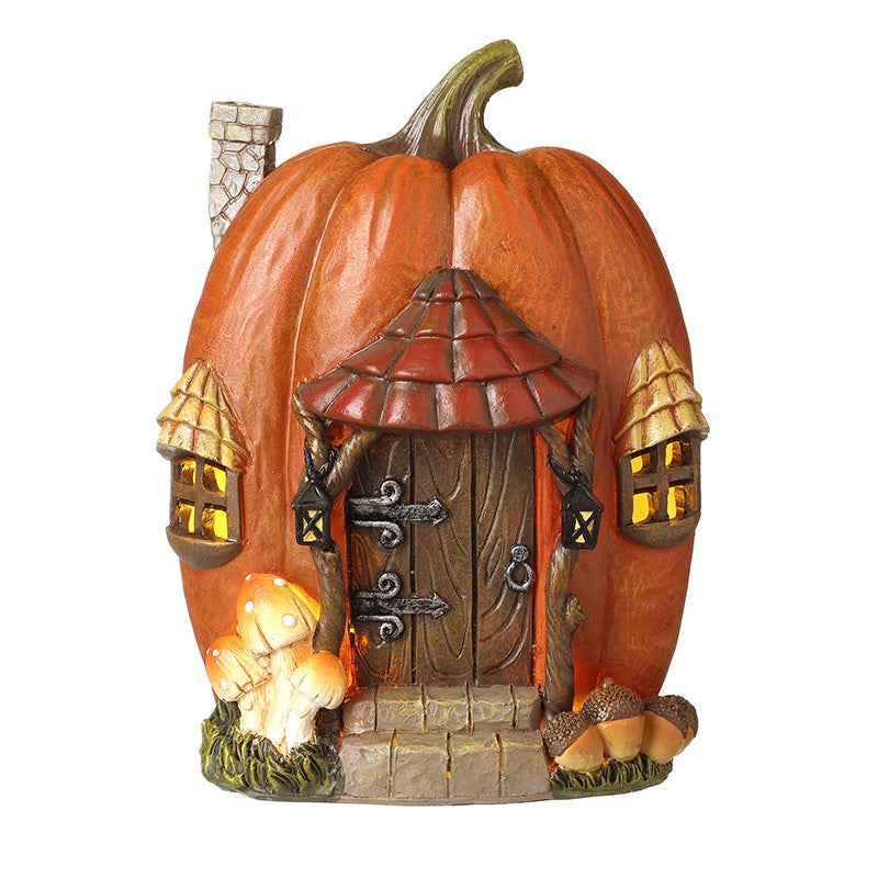 Pumpkin-shaped fairy house with a door and windows and led lighting