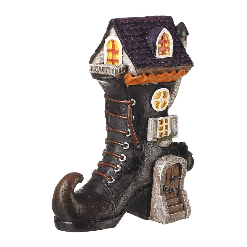 Decorative witch boot with house design with windows and doors