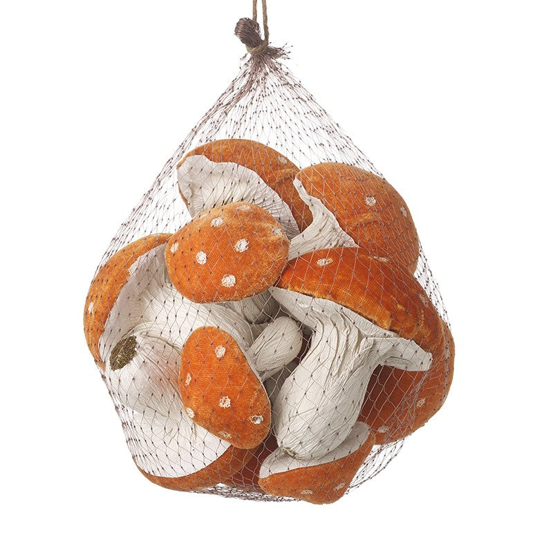 Bag of decorative mushrooms with orange and white caps on a white background