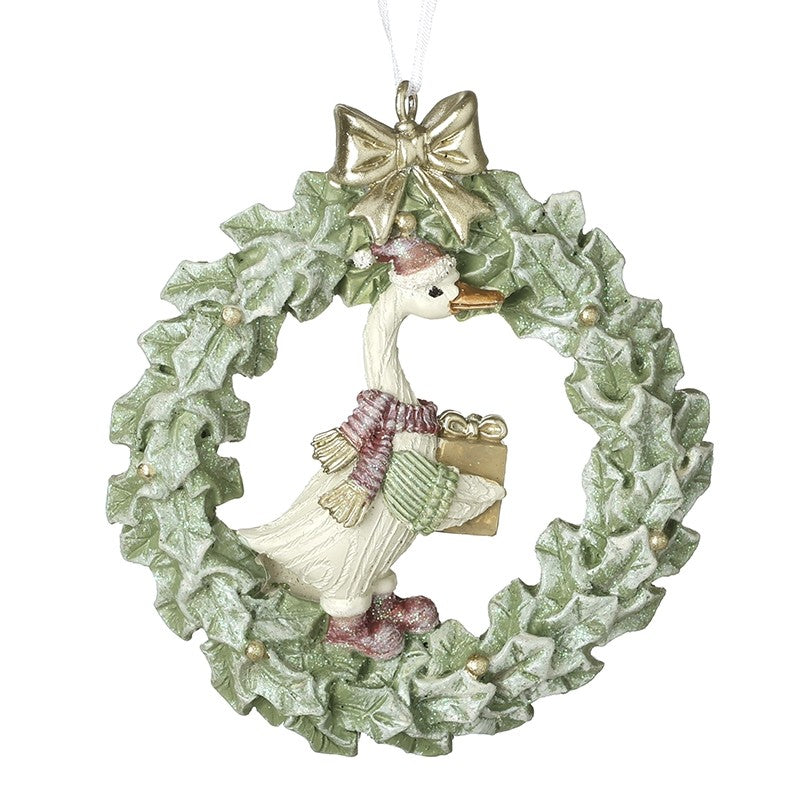 duck inside a wreath tree decoration with pink scarf holding a present