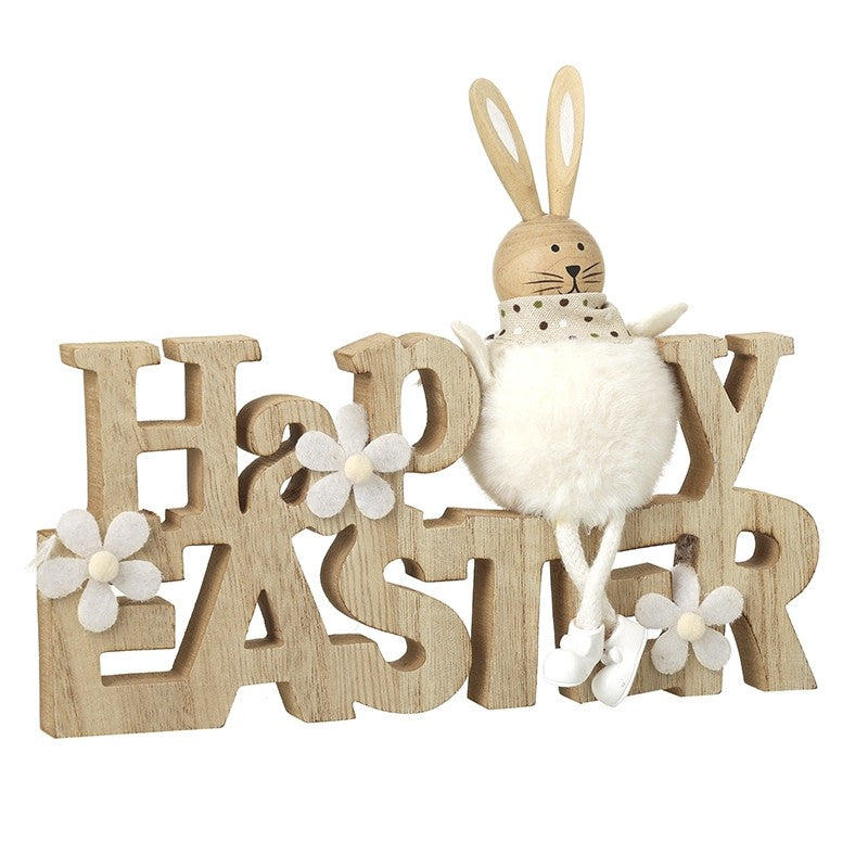 Decorative sign with wooden letters spelling 'Happy Easter' and a plush bunny with rabbit ears.