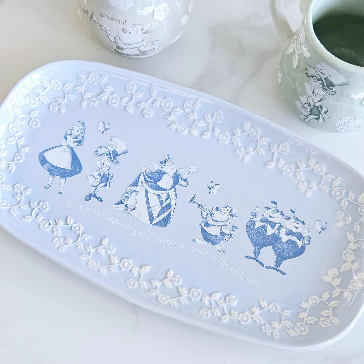 Alice in wonderland serving plate embossed detail and main characters illistrations