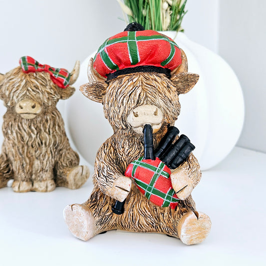 highland cow pipe piper bag pipes wearing tartan hat and bag pipes ornament