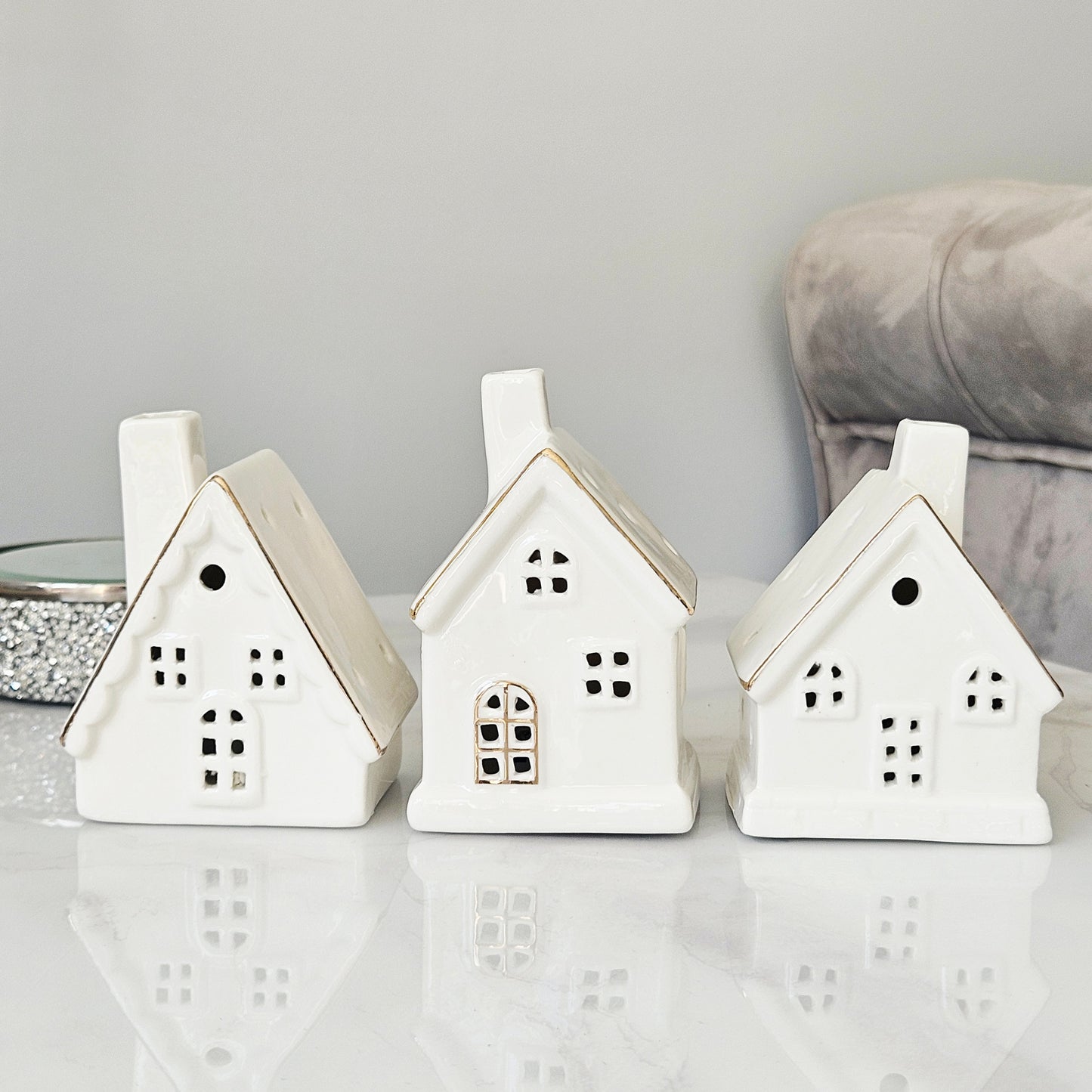 Three white ceramic house-shaped led lanterns christmas