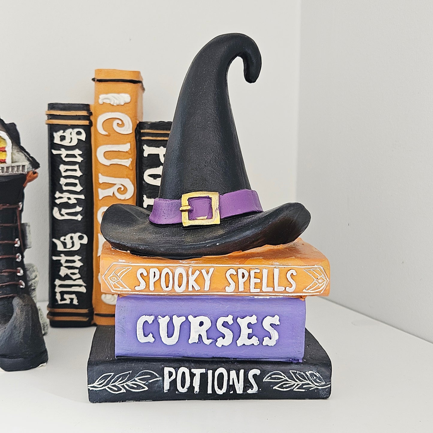 Witch hat on top of books with Halloween-themed text