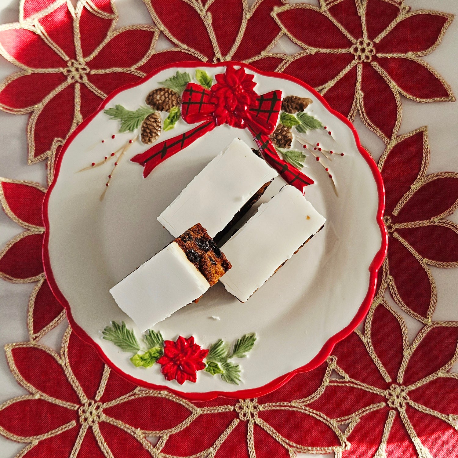 Decorative poinsettia cake stand with floral design and bow
