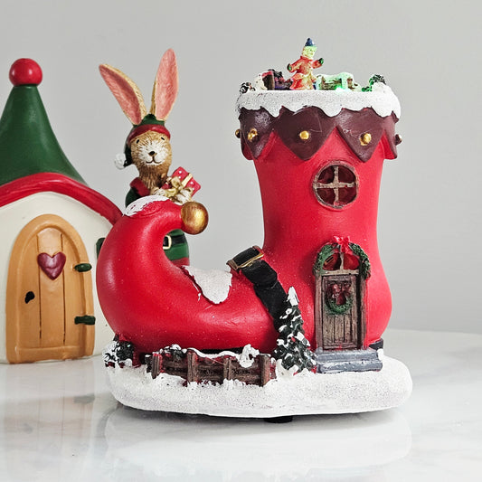 Decorative Christmas elf boot stocking with a miniature village inside and light up effects