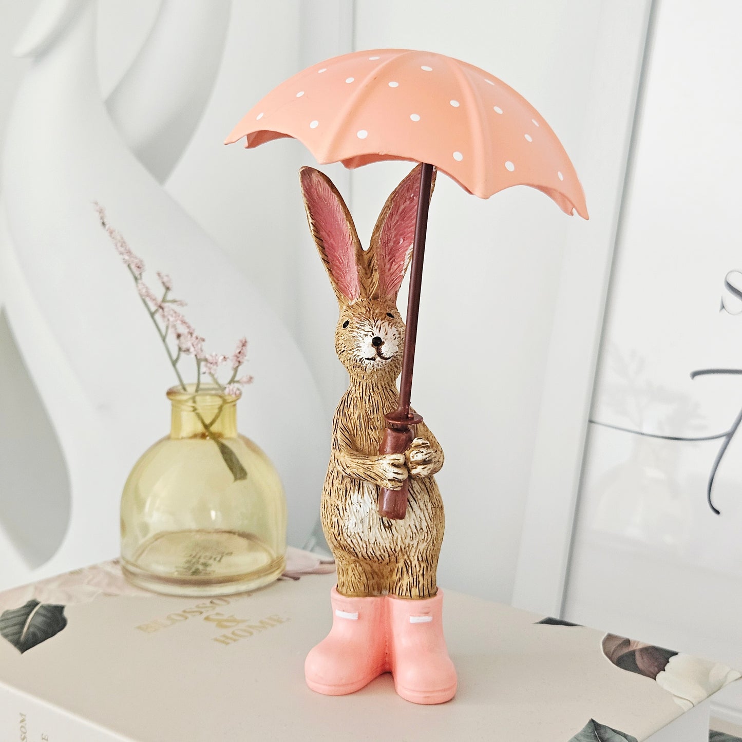 jasper rabbit ornament holding a pink umbrella with white spots and pink wellies 16cm