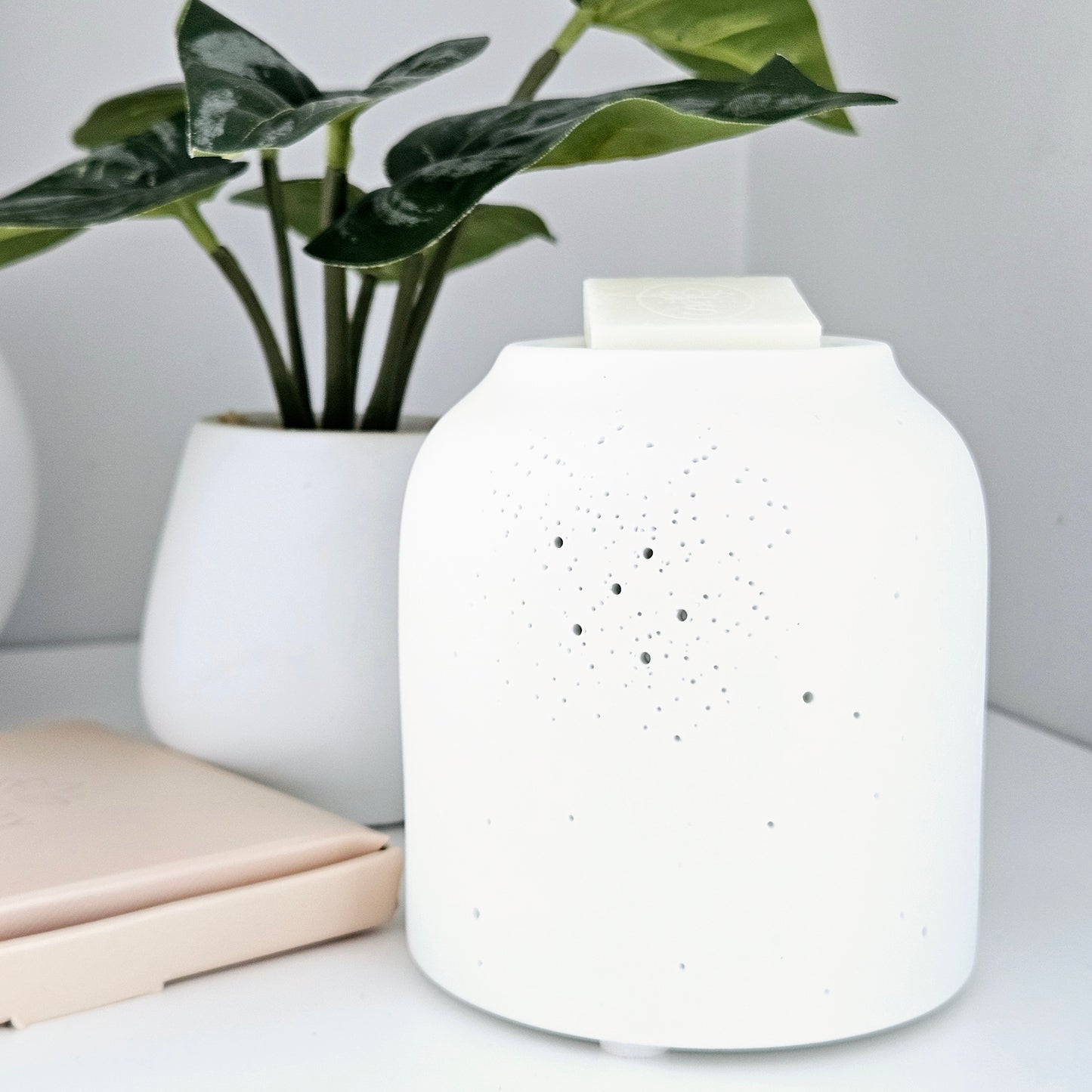 white pin holed ceramic wax and oil burner by hestia