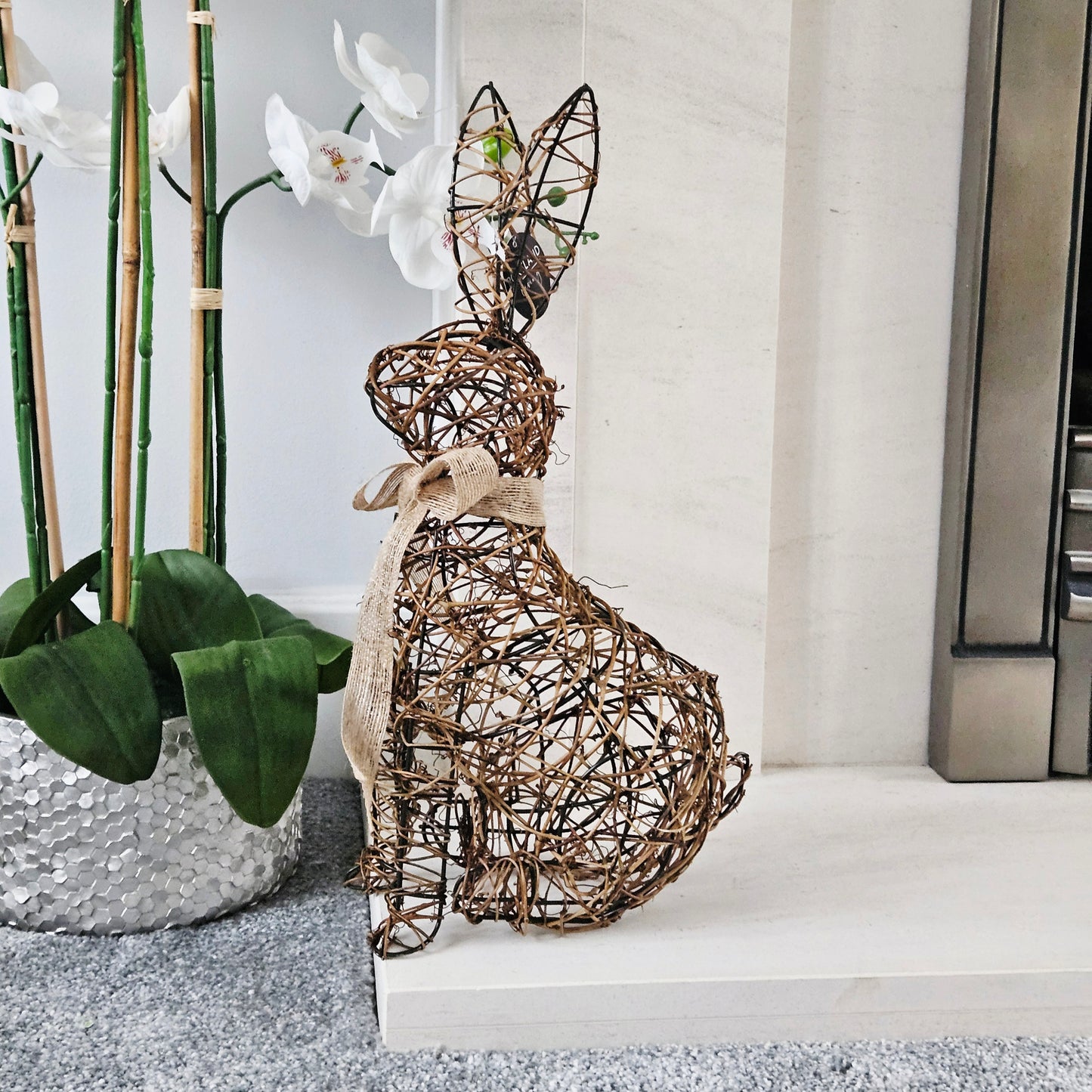 Decorative rattan rabbit sculpture with bow