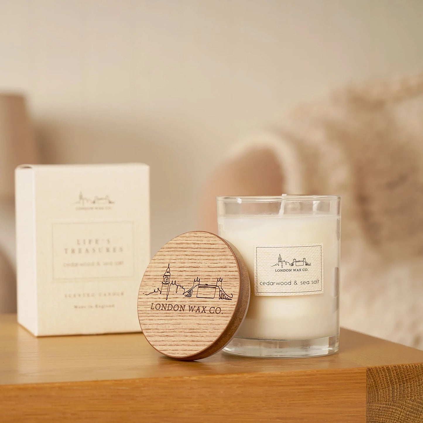 Candle and packaging with 'London Wax Co.' branding with wood lid and London drawn on top cedar wood and sea salt scent 226g