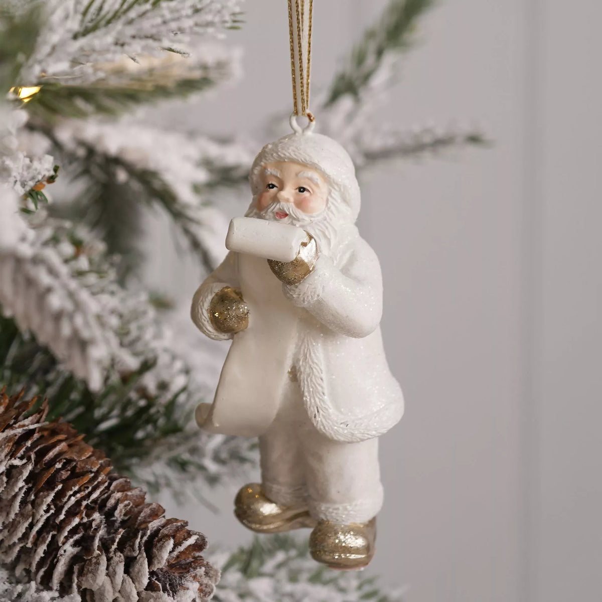 White and gold Santa reading a letter hanging Christmas tree decoration