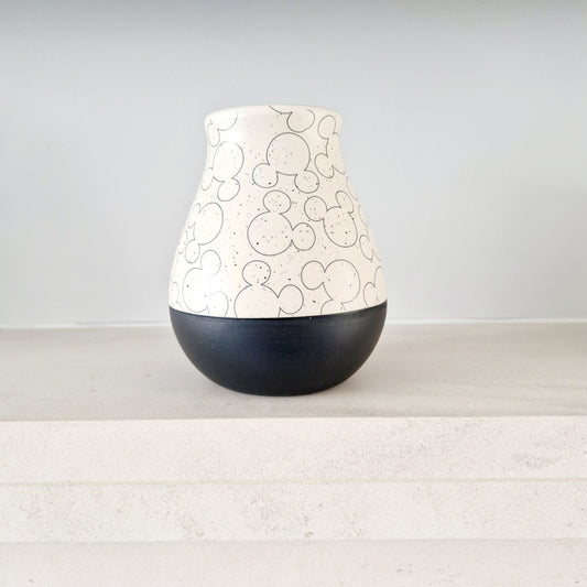 ceramic vase showcases a distinctive Mickey Mouse head design, complete with natural colouring, dipped effect and black banding around the bottom.