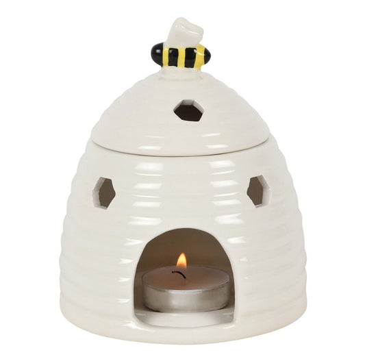 Ceramic oil burner and wax warmer comes in the shape of an adorable white beehive with a sweet bee on the lid