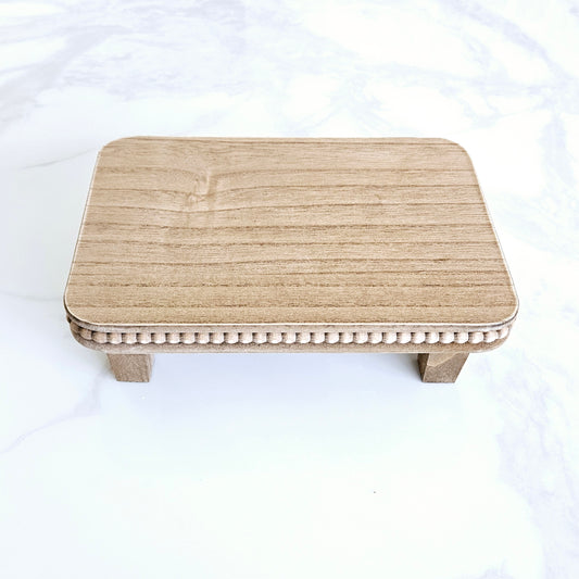 Natural wood beaded riser tray for styling
