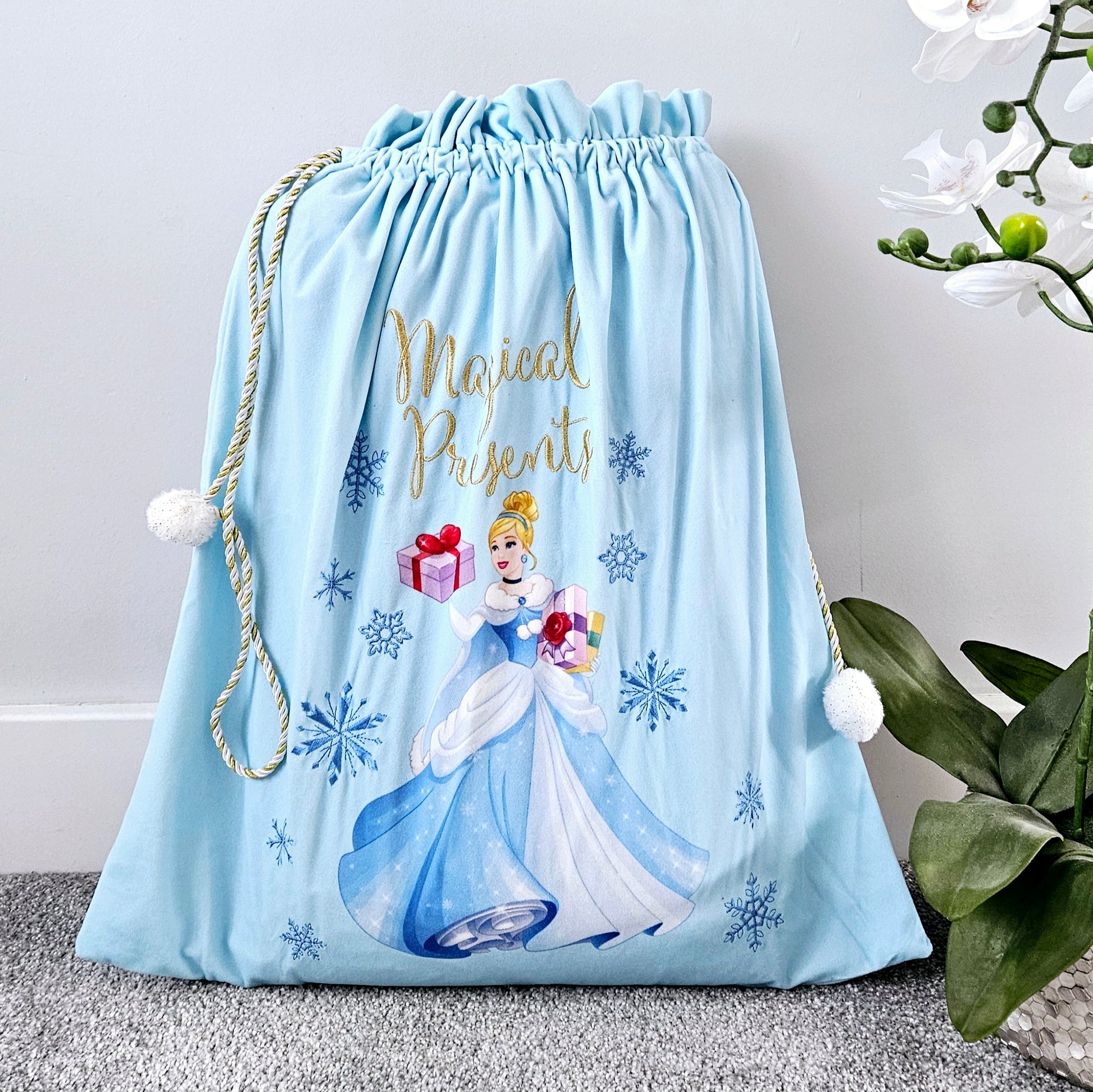 Cunderella christmas sack with gold string and white pom poms