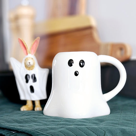 Ghost shaped mug all white with black eyes and black nose