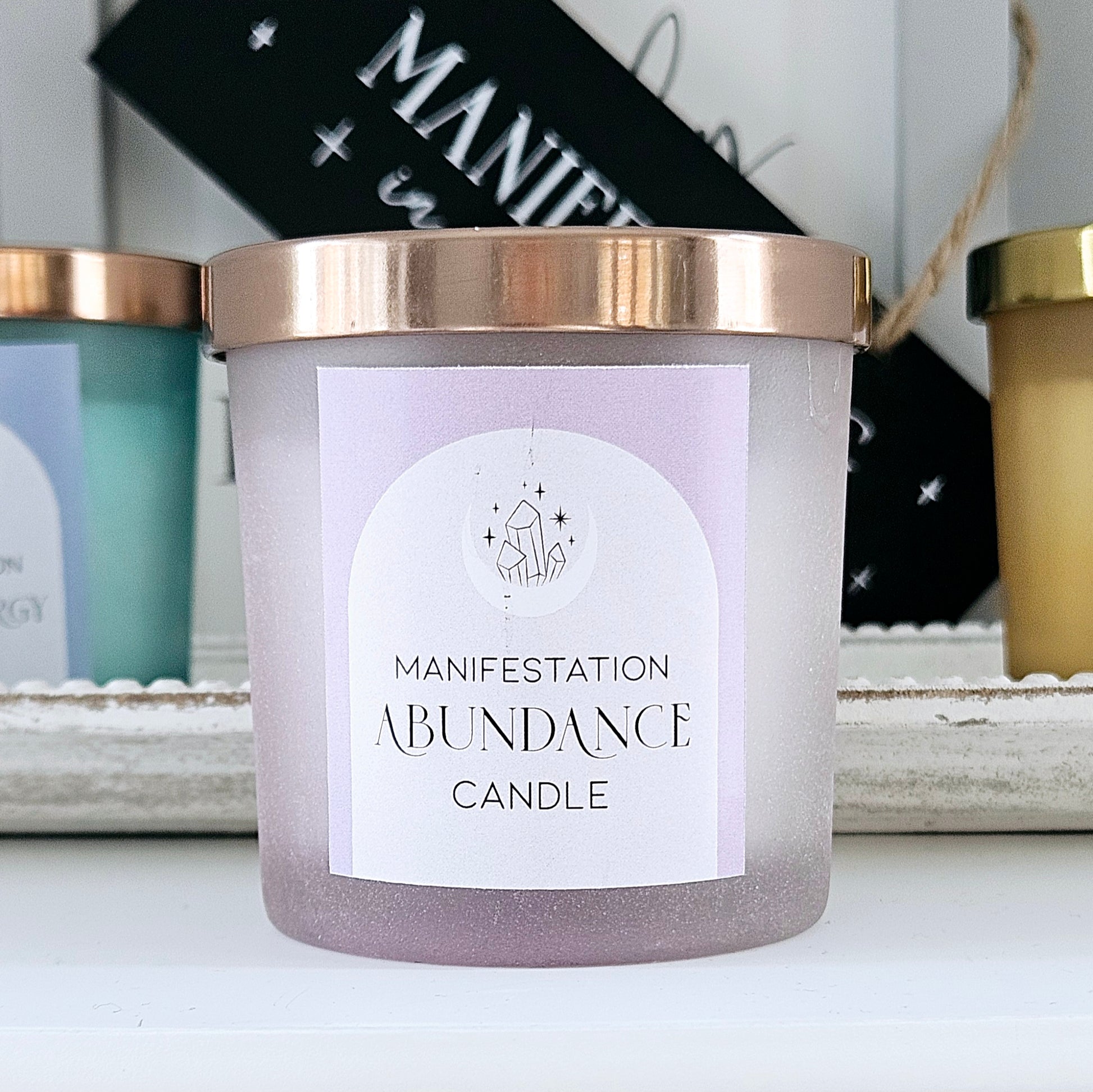 abundance manifesting candle with crystals in purple