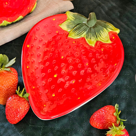 Strawberry shaped plate in red with a green stalk from cottage garden