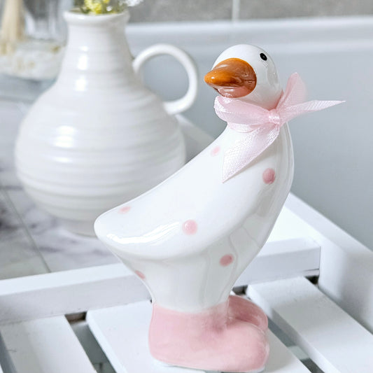 small ceramic duck with pink polka dot spots and pink bow and feet