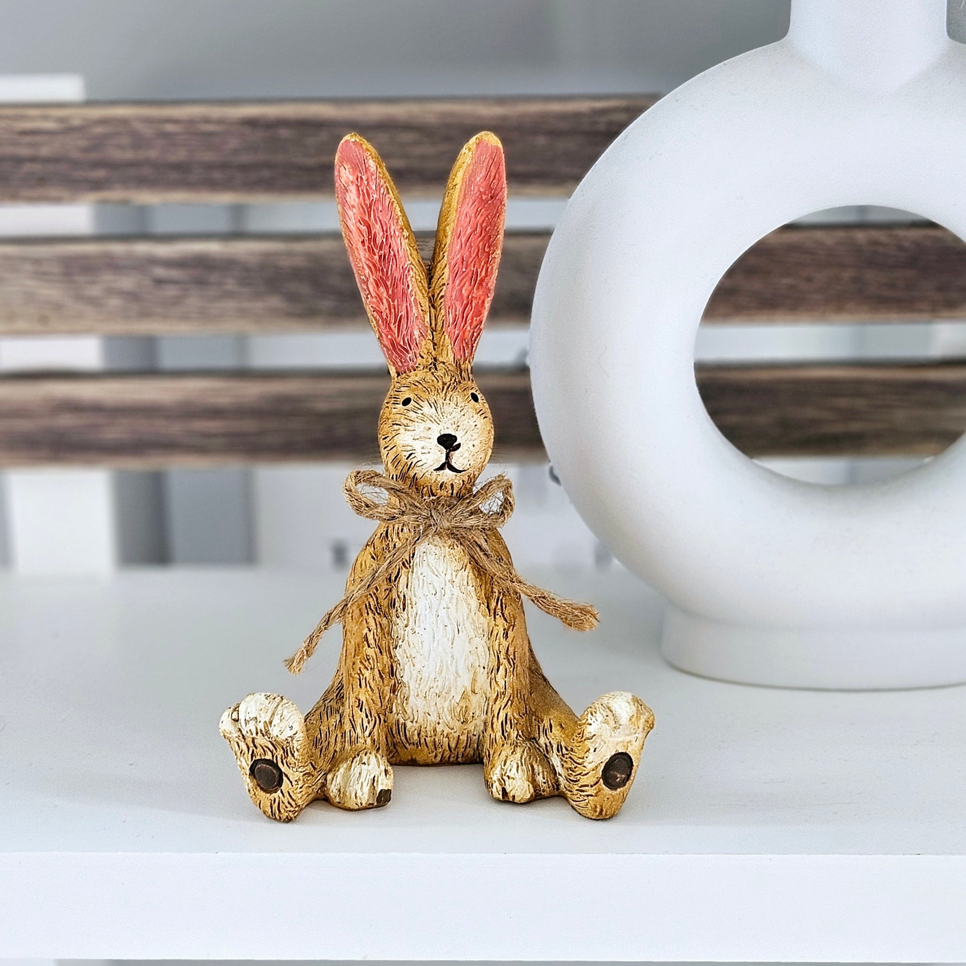 Sitting rabbit bunny figurine with a cute jute bow around its neck