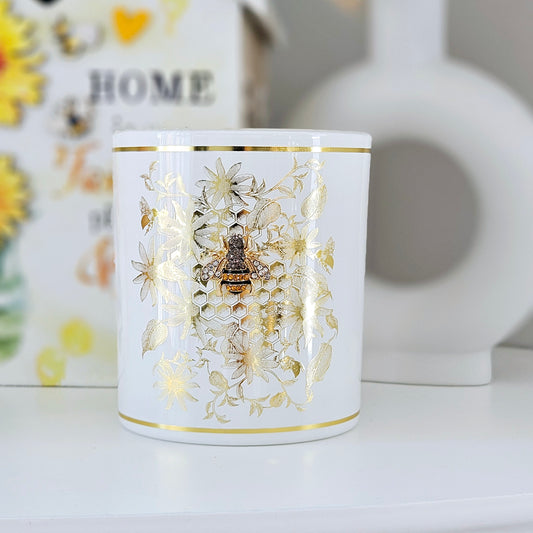 Honeycomb bee candle with diamond bee and gold leaf print in a white and gold pot