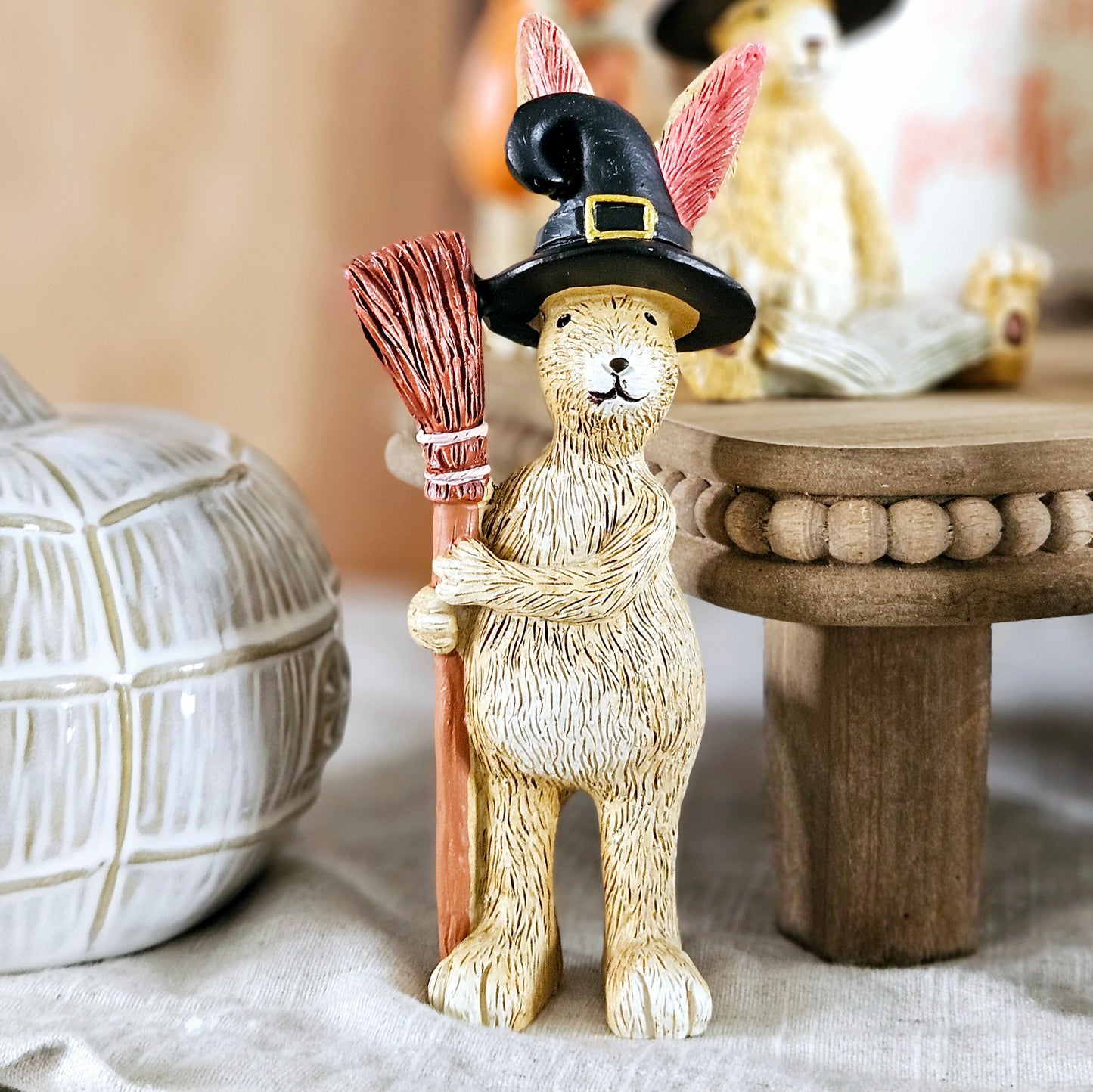 halloween rabbit standing ornament holding a broomstick and wearing a black witches hat