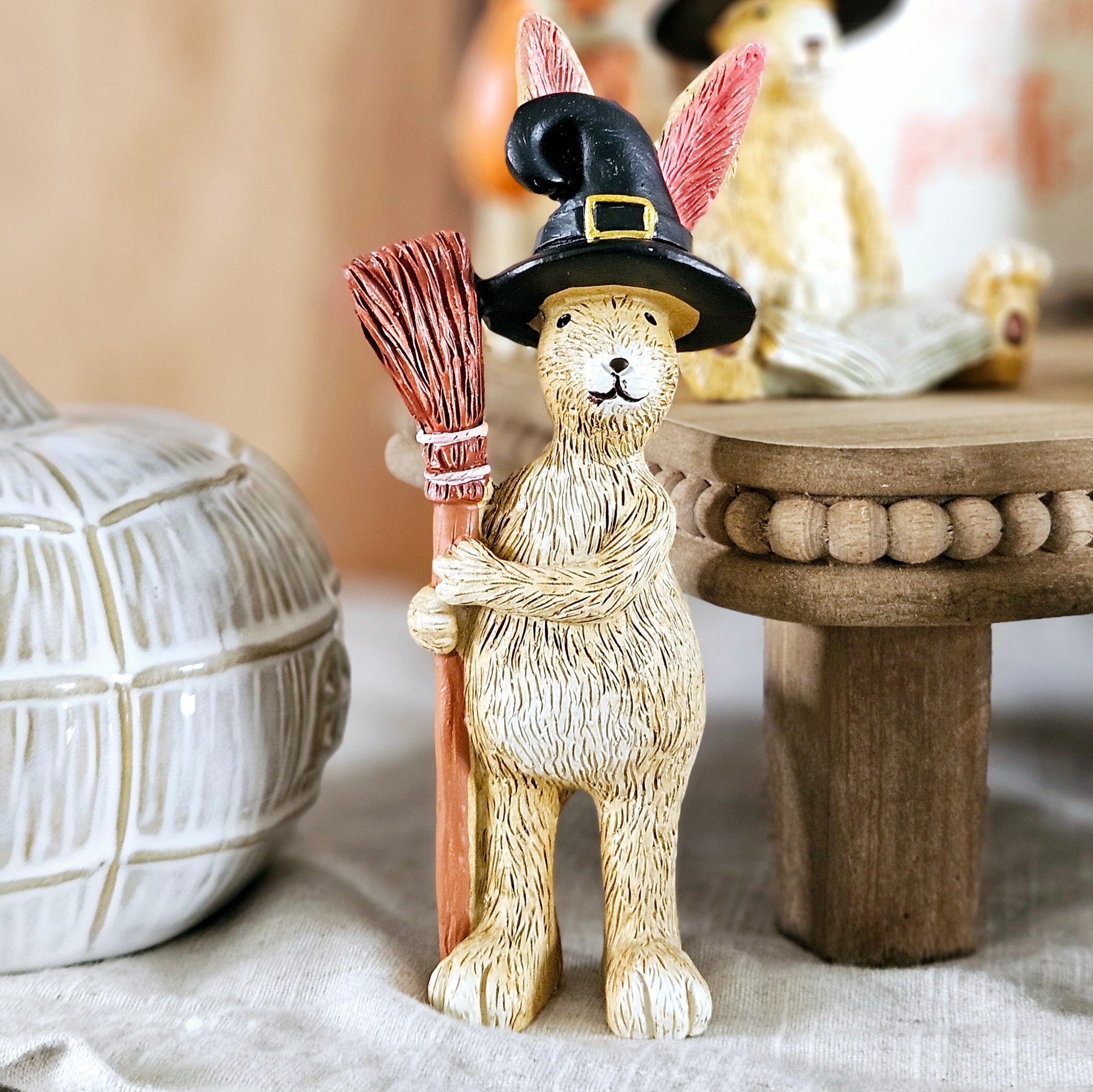 halloween rabbit standing ornament holding a broomstick and wearing a black witches hat