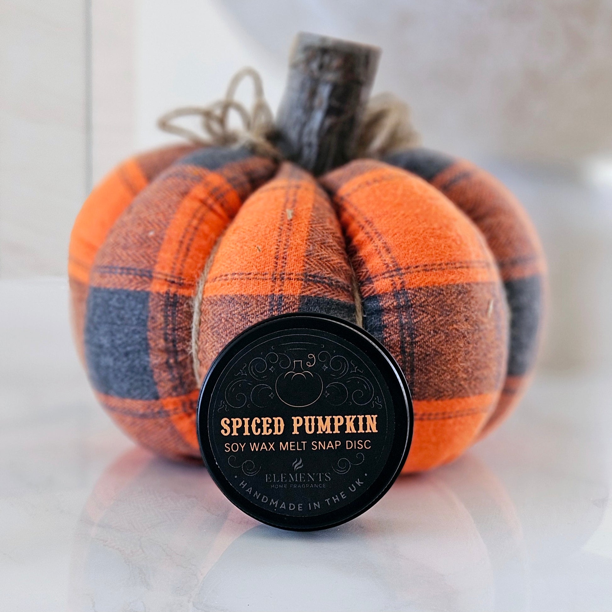 spiced pumpkin scented wax melt by elements in a tin