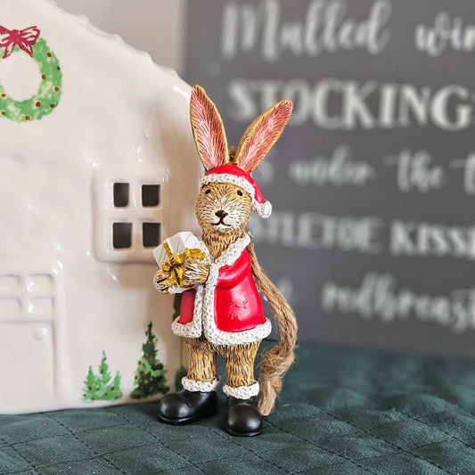 santa bunny ornament which hangs y a brown jute rope holding a present