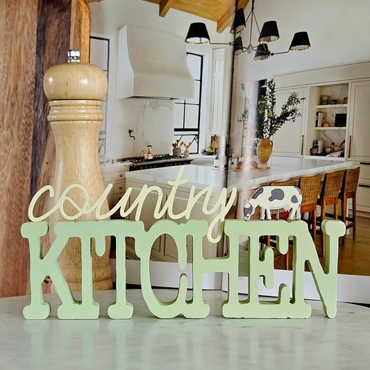 Country kitchen plaque with a cow figure attached 