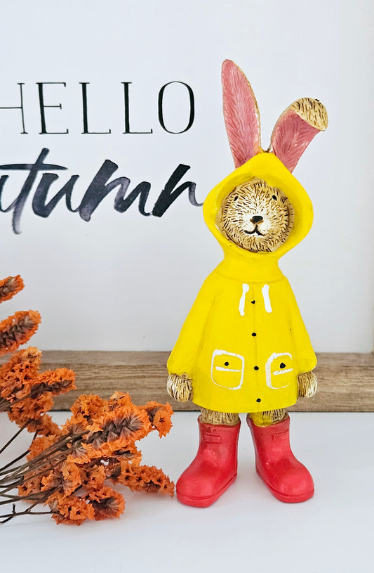 Jasper Rabbit wearing a yellow raincoat and red boots 