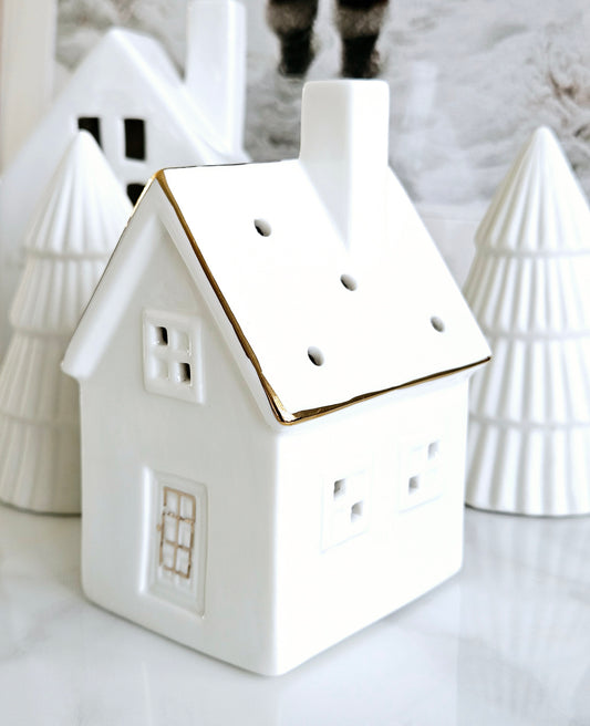 ceramic led house with circle cut outs on the roof and gold details